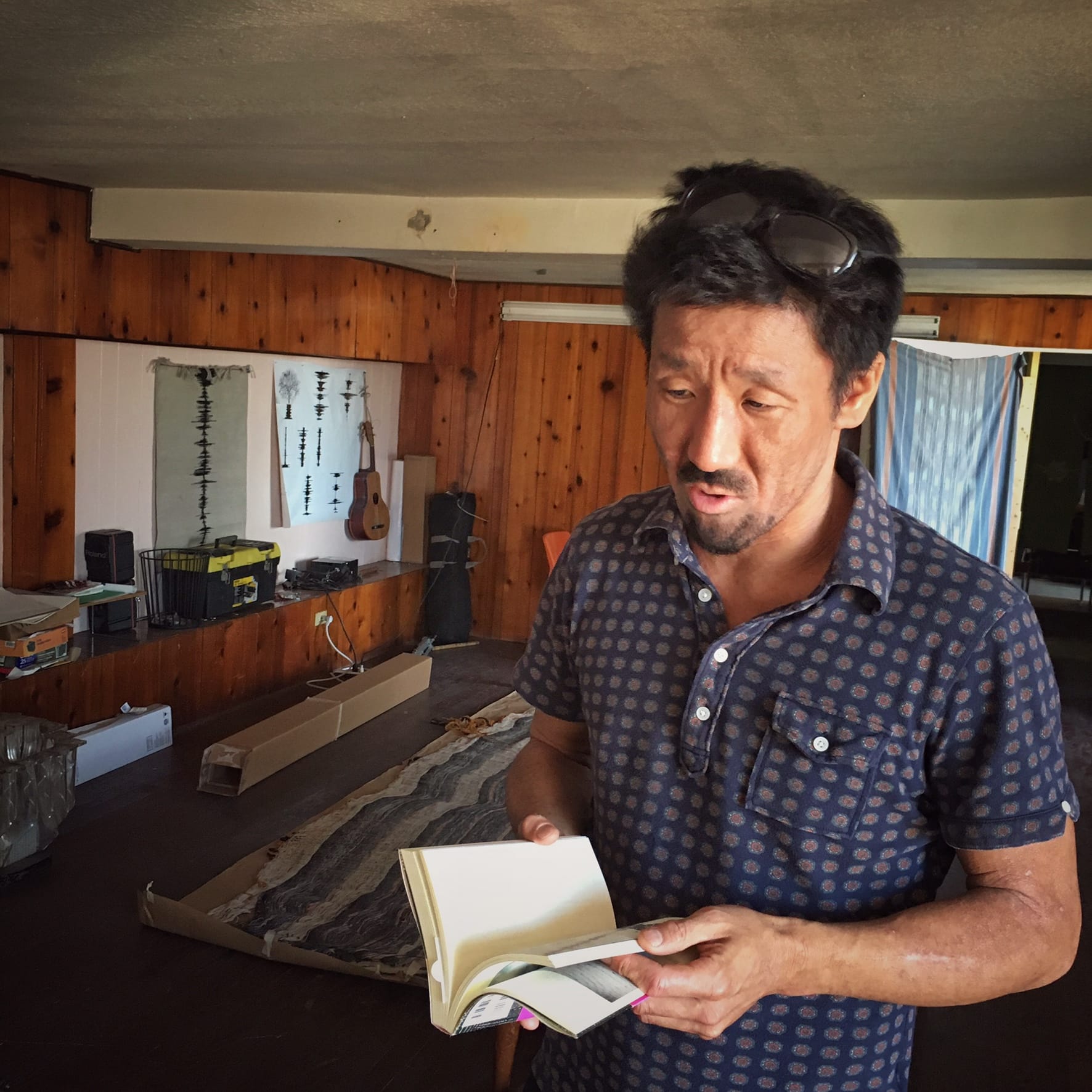 Takeda talks about the two Japanese published books about his work. Photo by Chi Essary